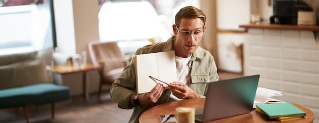 Person som sammenligner lån på laptop med notater